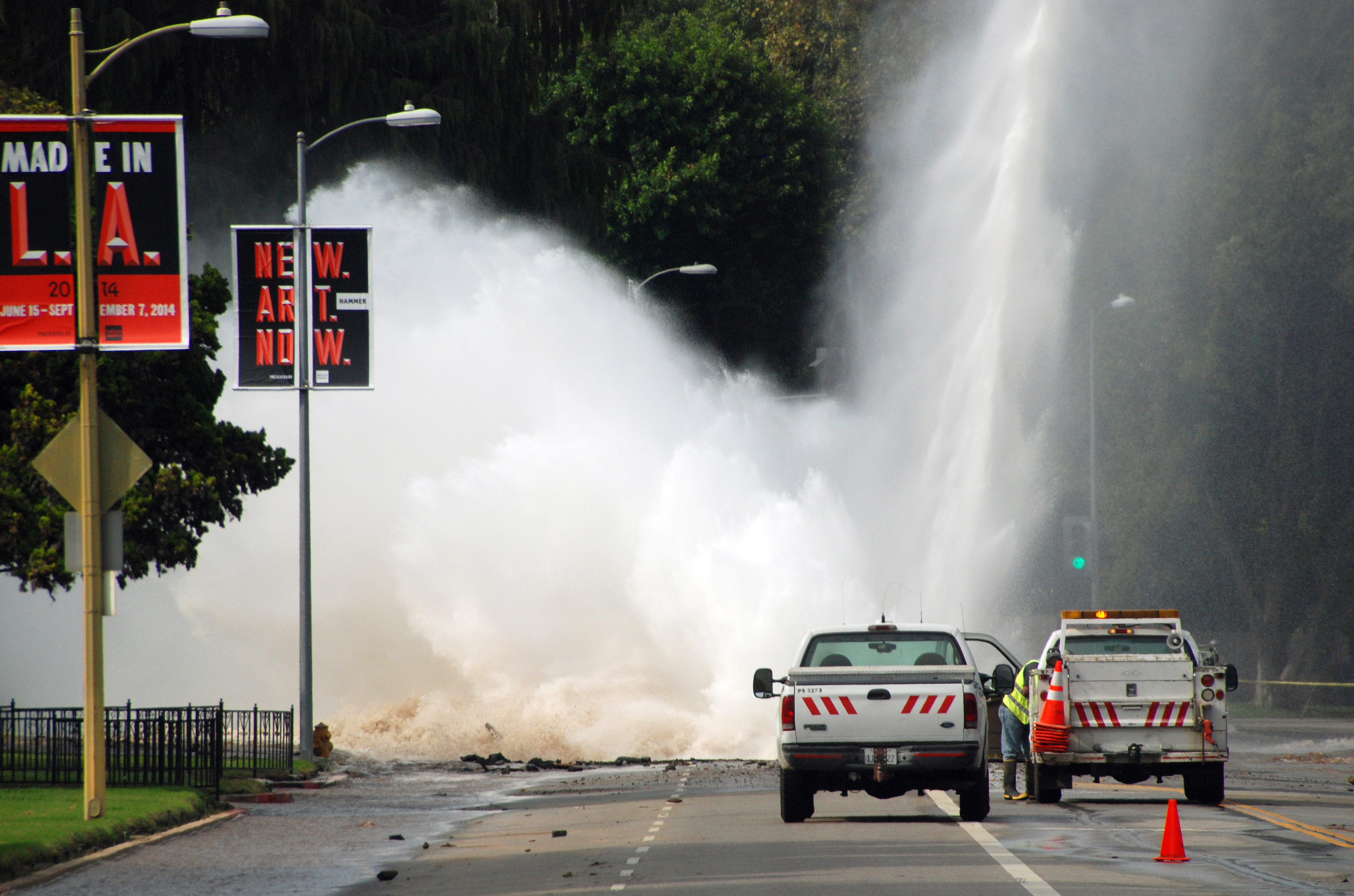 Water shoots in the air from a broken 30-inch water main under Sunset Boulevard, uphill from UCLA in the Westwood section of Los Angeles, Tuesday, July 29, 2014. The resulting flood inundated several areas of UCLA, including Pauley Pavilion, home of UCLA basketball, a parking structure and several other building. (AP Photo/Mike Meadows)